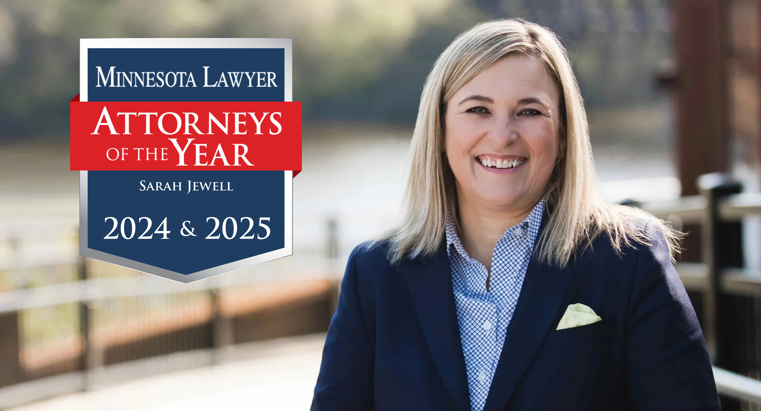 Sarah Jewell standing on a bridge with a river behind her smiling